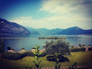 a view of a lake with mountains in the background at Il Cortile in Clusane sul Lago