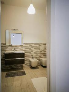 a bathroom with two sinks and a tub and a mirror at Il Cortile in Clusane sul Lago +44 photos