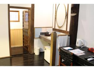 a small kitchen with a sink and a counter top at Kotohira Guest House en in Hita