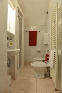 a bathroom with a white toilet and a sink at B&B Antiche Mura in Puegnago