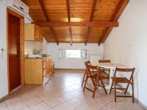 a kitchen with a table and chairs in a room at Hotel Olga in Agios Stefanos