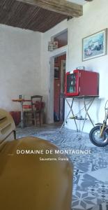 a room with a table and a motorcycle in it at Domaine de Montagnol in Sauveterre