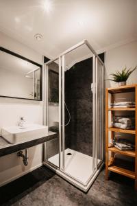 a bathroom with a shower and a sink at Flasch Appart-Pension in Wagrain