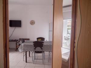 a dining room with a table and chairs at Apartments Boki in Pag