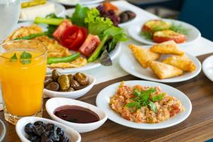 a table with plates of food and a glass of orange juice at ANGEL'S PARK HOTEL in Denizli