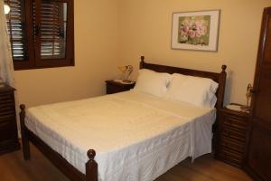 a bedroom with a bed with white sheets and white pillows at Quinta De Gestacos in Geres +39 photos