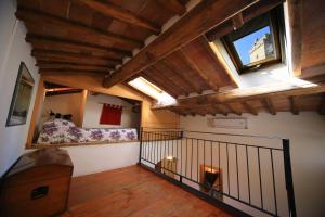 a bedroom with a bed and a window at Fabio Apartments San Gimignano in San Gimignano