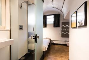 a bathroom with a door leading to a bedroom at CoDE Pod – The CoURT - Edinburgh in Edinburgh