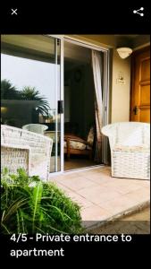 private entrance to an open patio with wicker chairs at Mulberry Gardens Self Catering in Swakopmund
