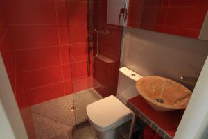 a bathroom with a toilet and a sink and a shower at Le Mesnil in Dancé