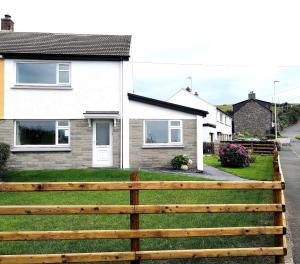 a wooden fence in front of a house at No.20 in Borth