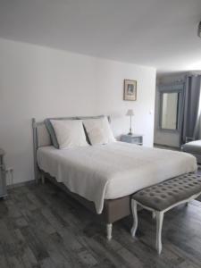 a bedroom with a large bed and a bench at Sous le mûrier in Six-Fours-les-Plages +59 photos