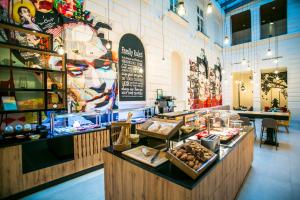 a bakery filled with lots of different types of baked goods at T62 Hotel in Budapest