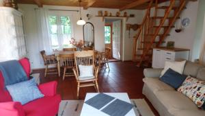 a living room with a couch and a table at Dom pod strzecha in Łajs