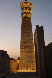 una torre alta frente a un edificio en Minorai Kalon Boutique Hotel, en Bukhara