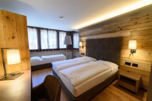 Ένα ή περισσότερα κρεβάτια σε δωμάτιο στο Hotel Crozzon