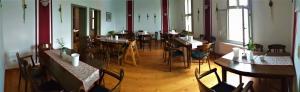 a dining room with tables and chairs in a restaurant at Hotel Gasthaus Weisser Mönch in Blankenburg