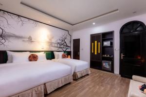 Voodi või voodid majutusasutuse Hanoi Center Silk Lullaby Hotel and Travel toas