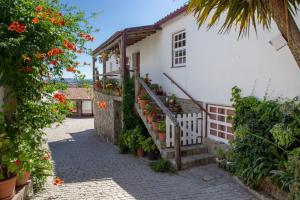 a house with flowers and stairs in a street at Quinta Da Estrada Winery Douro Valley in Peso da Régua