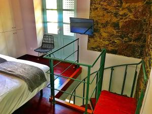 a room with a bed and a glass table with a television at Hotel Rural Triana in Vallehermoso