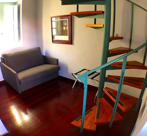 a living room with a spiral staircase and a couch at Hotel Rural Triana in Vallehermoso