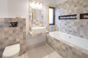 a bathroom with a tub and a toilet and a sink at The Lodges at Artlegarth in Ravenstonedale