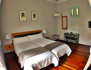 a bedroom with a large bed with white sheets at Hotel Rural Triana in Vallehermoso