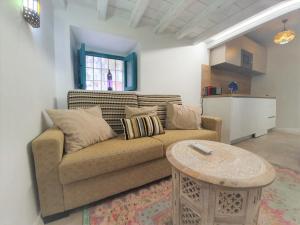 a living room with a couch and a table at Riad Puertas del Albaicín in Granada