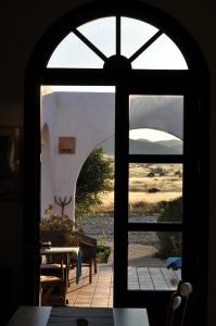 an open door to a patio with a table outside at Cortijo el Campillo in Los Albaricoques