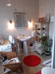 a bathroom with a sink and a table and a shelf at Les Alouettes B&B in Hardecourt-aux-Bois