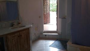 a bathroom with a sink and an open door at villa PICOZZI cannigione in Cannigione +20 photos