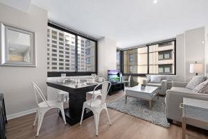 a living room with a table and chairs and a couch at Global Luxury Suites Downtown Jersey City in Jersey City +20 photos