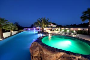 a swimming pool in a resort at night at Rancho Relaxo - "A Luxurious Hideaway for Couples and Honeymooners" in Nicosia