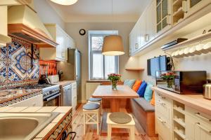 a kitchen with a table and a couch in it at Grand Apartments - Monte Cassino Blanco in Sopot