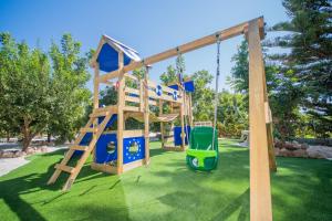 a playground with a slide and a swing at Cubo's Casa Rural Tirado in Alhaurín el Grande