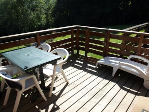 a table and chairs on a wooden deck at Chalet La Piste Bleu in Saint-Gervais-les-Bains
