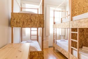 Ένα ή περισσότερα κρεβάτια σε δωμάτιο στο Queen's Garden Hostel