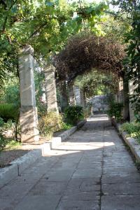 a stone pathway with an arch in a park at Dimora Storica ''Casa Sicuro'' in Martano