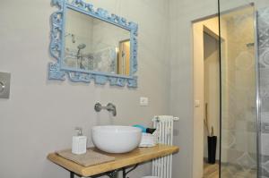 a bathroom with a sink and a mirror at Civico51 in San Damiano dʼAsti