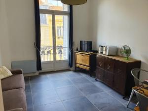 a living room with a couch and a window at Studio Astoria in Menton