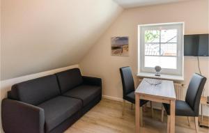 a living room with a couch and a table at Cozy Apartment In Emmelsbll-horsbll With Wifi in Emmelsbüll-Horsbüll