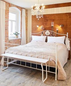 a bedroom with a white bed and a chandelier at Strohhutmanufaktur in Dresden