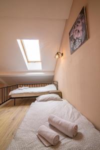 two beds in a room with a window at Duplex in New Gudauri, block 4 in Gudauri