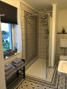 a bathroom with a shower with a glass door at B&B Holset70 in Lemiers +84 photos
