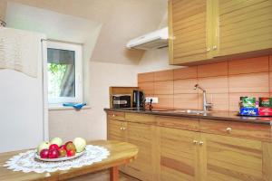a kitchen with a bowl of fruit on a table at Second Floor Apartament in Liepāja