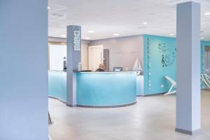 a man sitting at a counter in an office lobby at NURA Boreal in Playa de Palma +45 photos