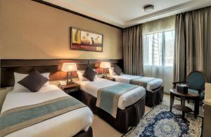 Voodi või voodid majutusasutuse Afraa Hotel Al Aziziya toas