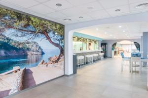 a room with a wall mural of the ocean at NURA Boreal in Playa de Palma