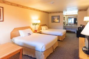 a hotel room with two beds and a window at The Redwood Riverwalk, a boutique hotel in Fortuna