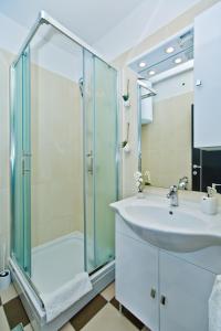a bathroom with a glass shower and a sink at HVAR apartments 8 min to the beach in Hvar +94 photos